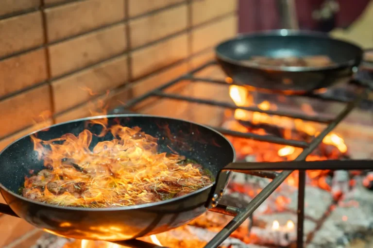 Cooking on a skillet on a grill with live fire.