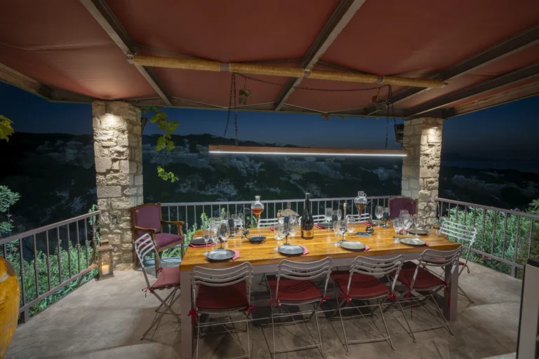 Lit up wine tasting table at night overlooking Zourida Gorge.